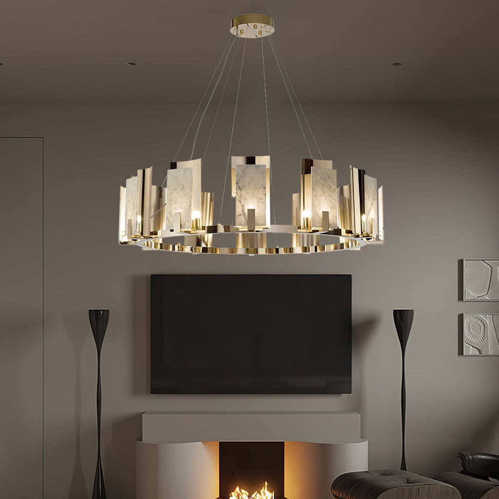 Clérachic Alabaster Ring Chandelier lit in a dim living room above a wall-mounted screen and the glow of a lit fireplace.