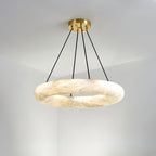 The wider Clérachic Alabaster Ring Chandelier hung in a white corner, its stone band catching light along the inner edge.