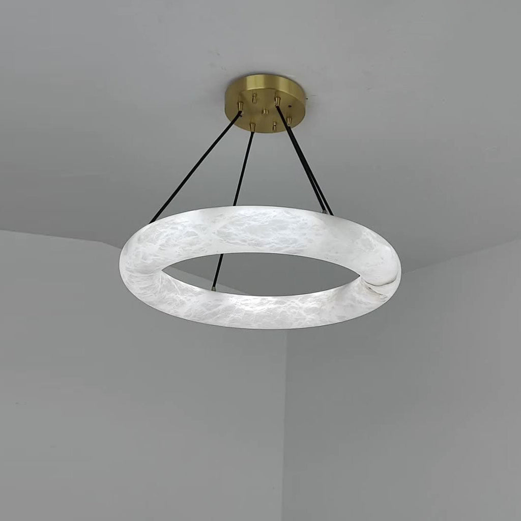 Clérachic Alabaster Ring Chandelier fitted in a grey ceiling corner, cool white stone and the join where the ring closes.
