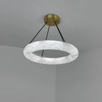 Clérachic Alabaster Ring Chandelier fitted in a grey ceiling corner, cool white stone and the join where the ring closes.