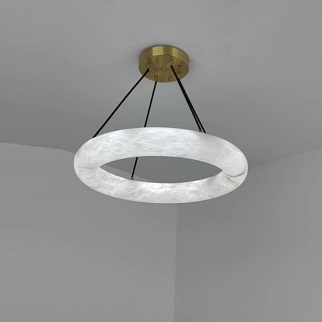 Clérachic Alabaster Ring Chandelier fitted in a grey ceiling corner, cool white stone and the join where the ring closes.