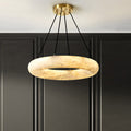 Clérachic Alabaster Ring Chandelier lit against dark panelled joinery, four black cords running up to the brass canopy.