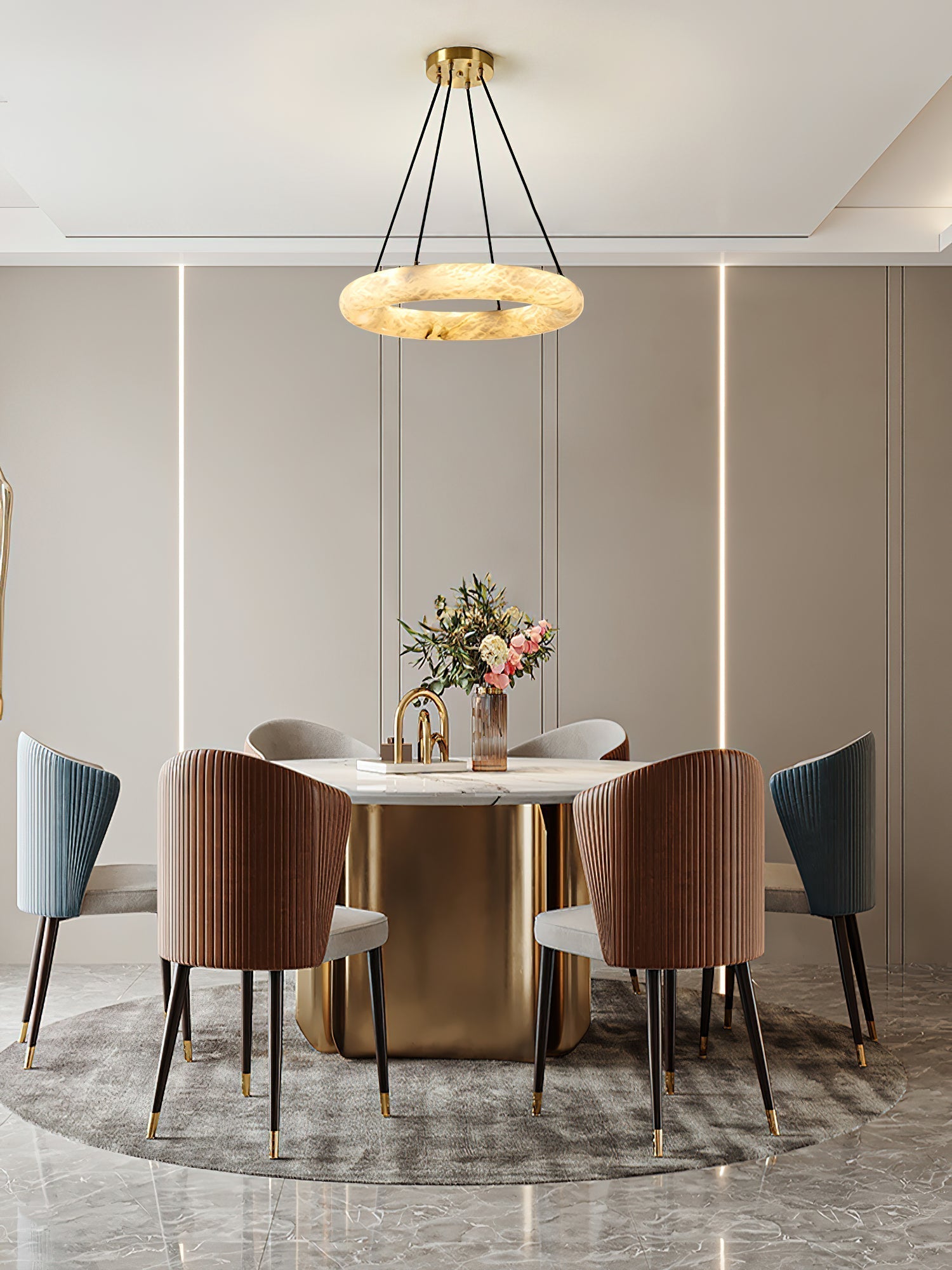 Clérachic Alabaster Ring Chandelier glowing over a round marble dining table ringed with fluted velvet dining chairs.