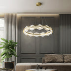 Clérachic Alabaster Ring Chandelier lit over a living room with grey panelled walls, a linen curtain and a tall plant.