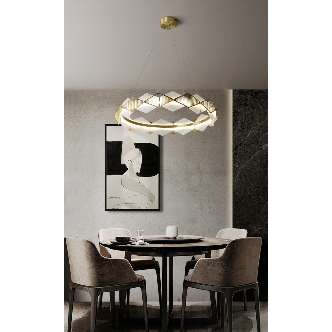 Clérachic Alabaster Ring Chandelier hung over a round dining table for four, framed by a print and a dark marble wall.