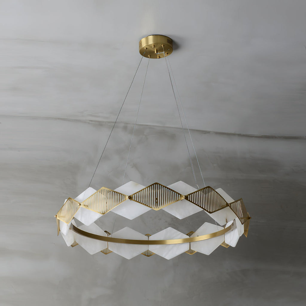 Clérachic Alabaster Ring Chandelier switched off on grey plaster, chalk-white stone panels set against warm brass.