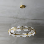 Clérachic Alabaster Ring Chandelier switched off on grey plaster, chalk-white stone panels set against warm brass.