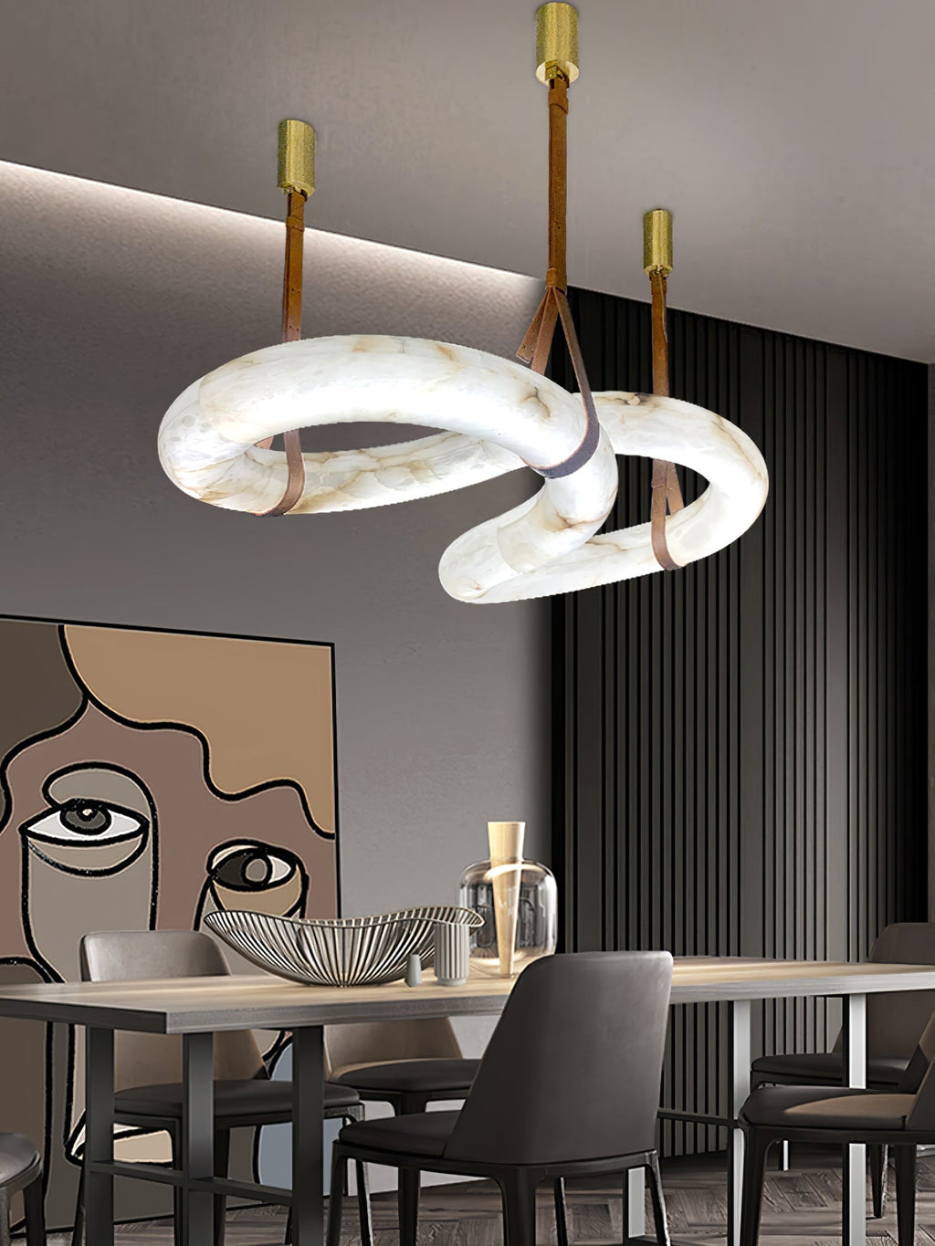 Warm caramel veining shows in the Clérachic Alabaster Ring Chandelier hung over a dining table beside a dark slatted wall.