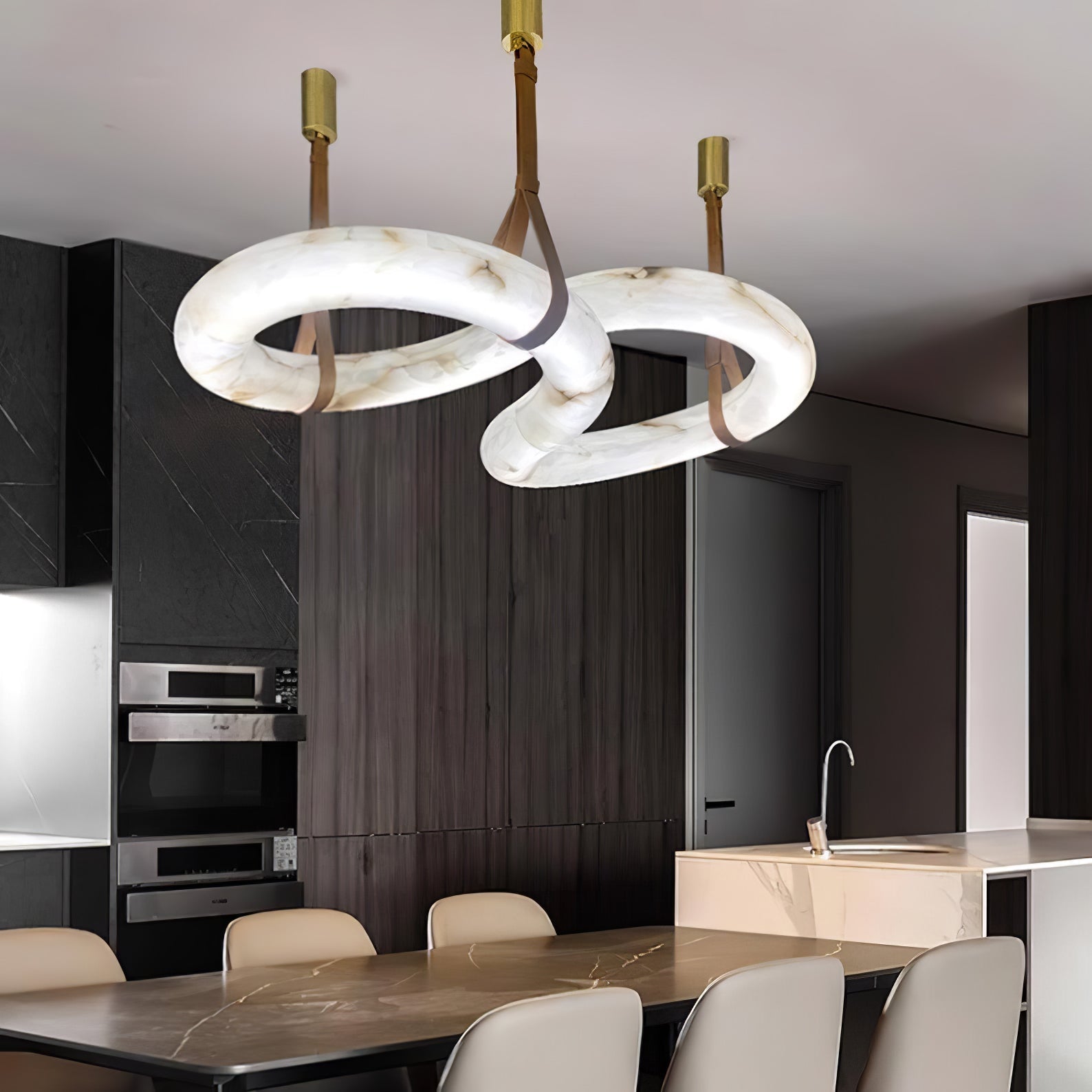 Clérachic Alabaster Ring Chandelier over a dining table in a dark timber kitchen, cream stone bright against black cabinetry.