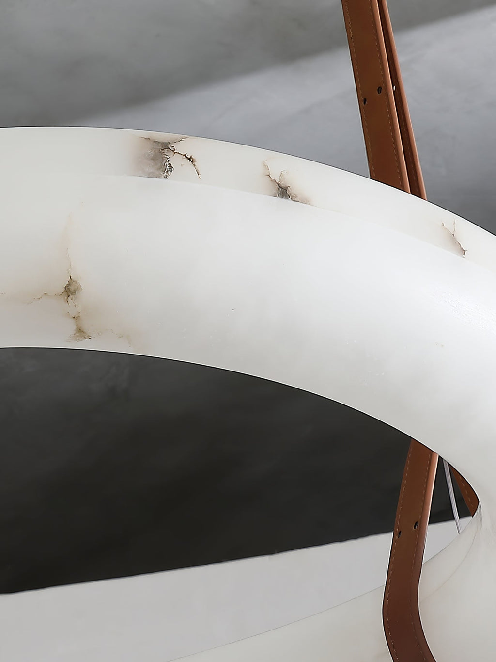 Close-up of the Clérachic Alabaster Ring Chandelier stone, amber veining running through the polished cream alabaster.