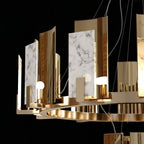 Detail of the Clérachic Alabaster Ring Chandelier: natural alabaster panels with grey veining set beside polished copper-toned shields on the ring.