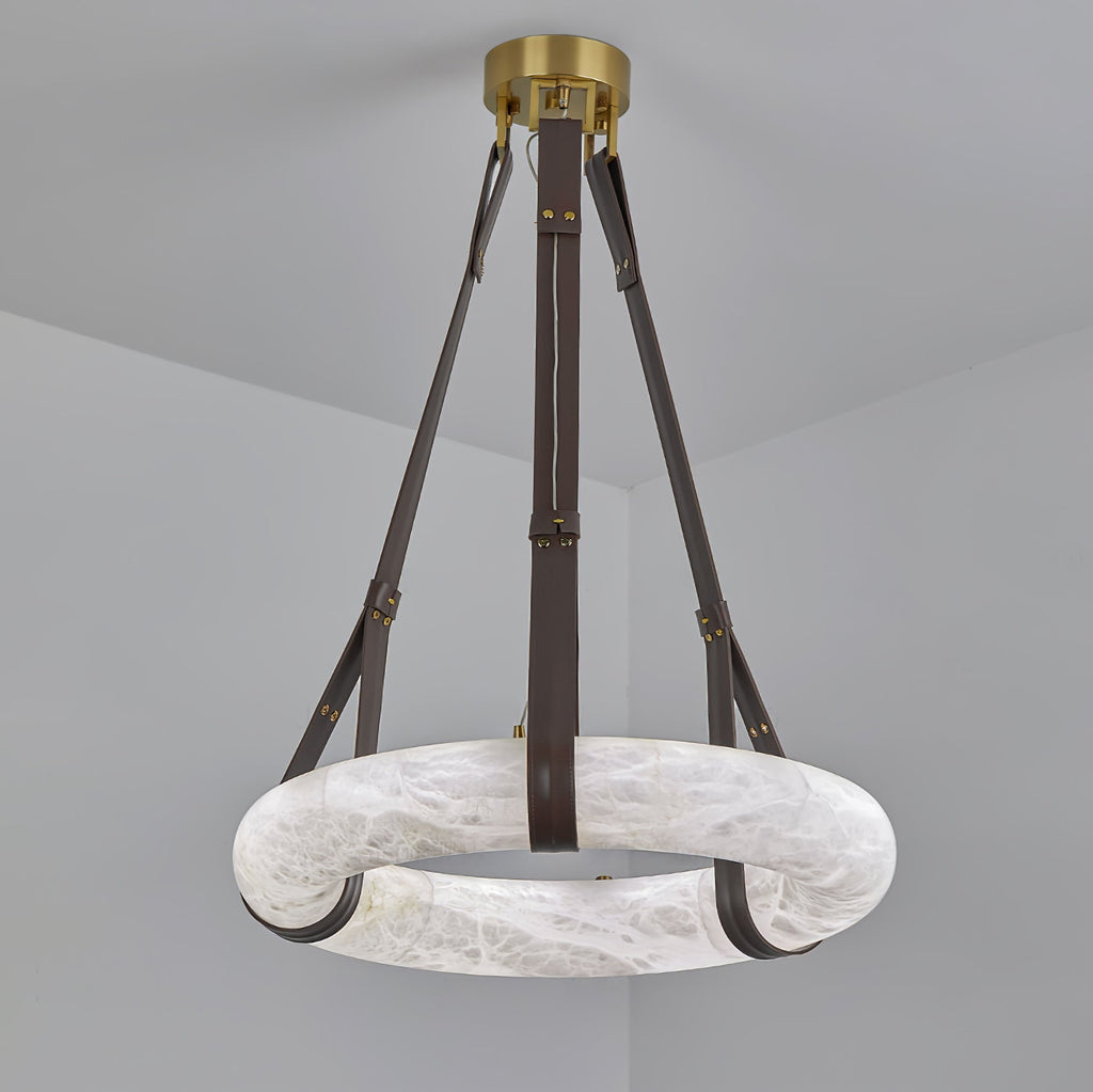 The Clérachic Alabaster Ring Pendant Light hung unlit, its dark brown straps meeting at the round brass canopy overhead.