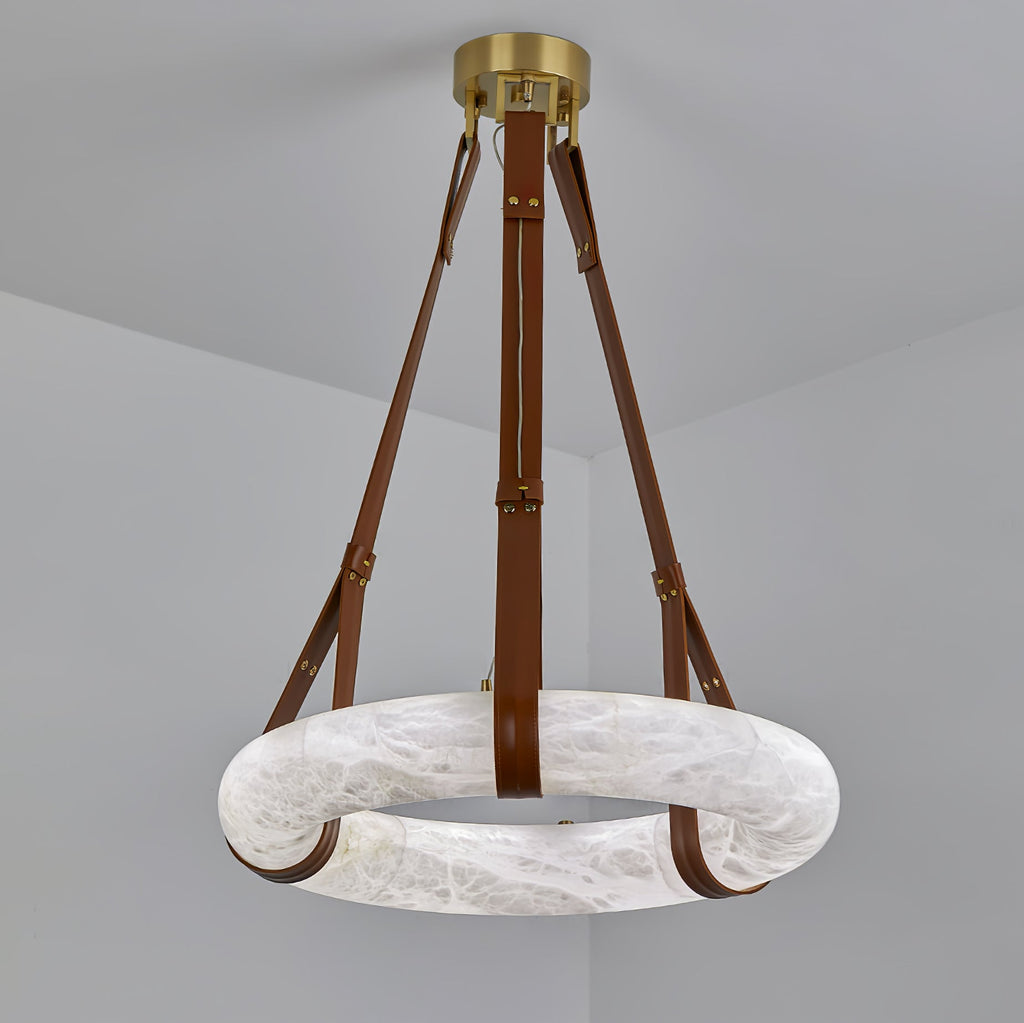 Clérachic Alabaster Ring Pendant Light shown with tan brown leather straps, the pale stone hoop hanging flat below the brass canopy.