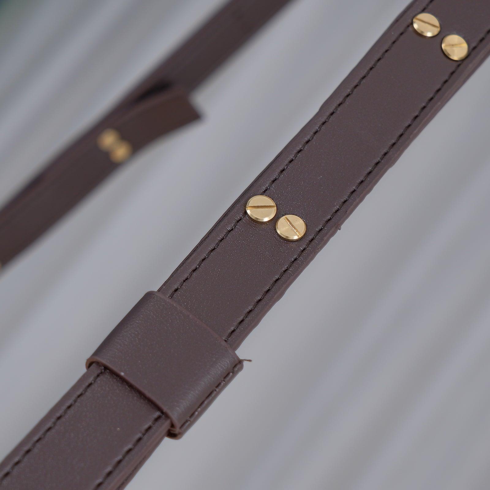Close-up of the dark brown leather strap on the Clérachic Alabaster Ring Pendant Light, stitched along the edge and set with brass screws.