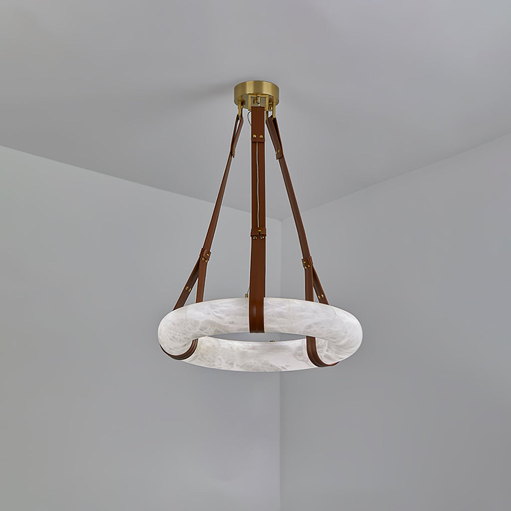 Clérachic Alabaster Ring Pendant Light hung in a grey corner, brown straps running from the brass canopy to the unlit stone ring.