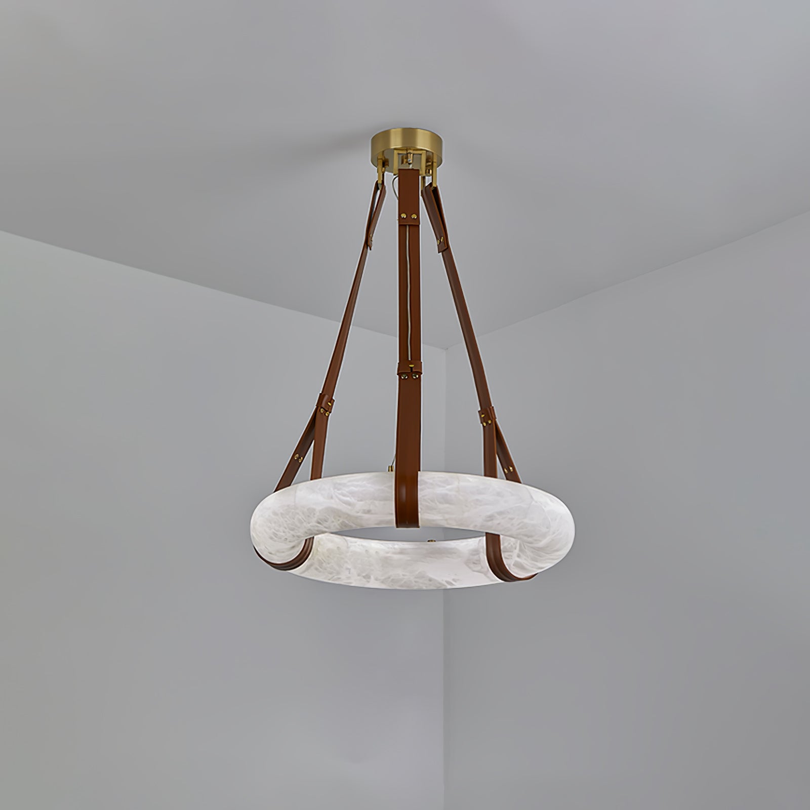Clérachic Alabaster Ring Pendant Light hung in a grey corner, brown straps running from the brass canopy to the unlit stone ring.