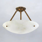 Unlit, the cool white alabaster bowl of this Clérachic ceiling light shows soft grey veining on a pale grey backdrop.