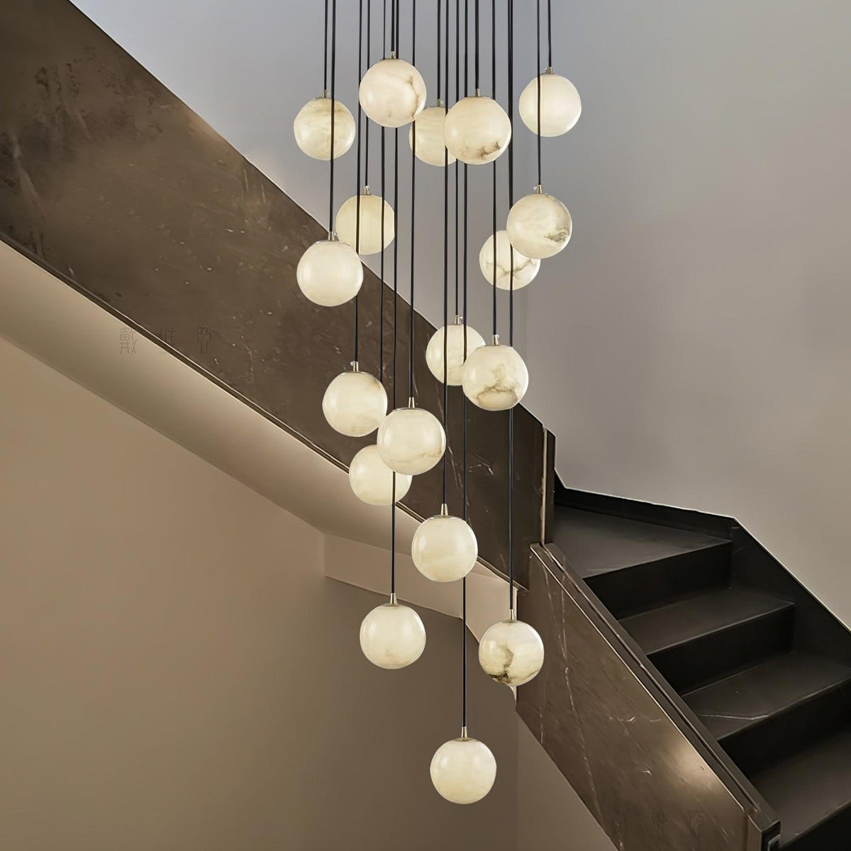 Clérachic alabaster spheres drop at different heights past a dark marble stair wall, each glowing a soft white.