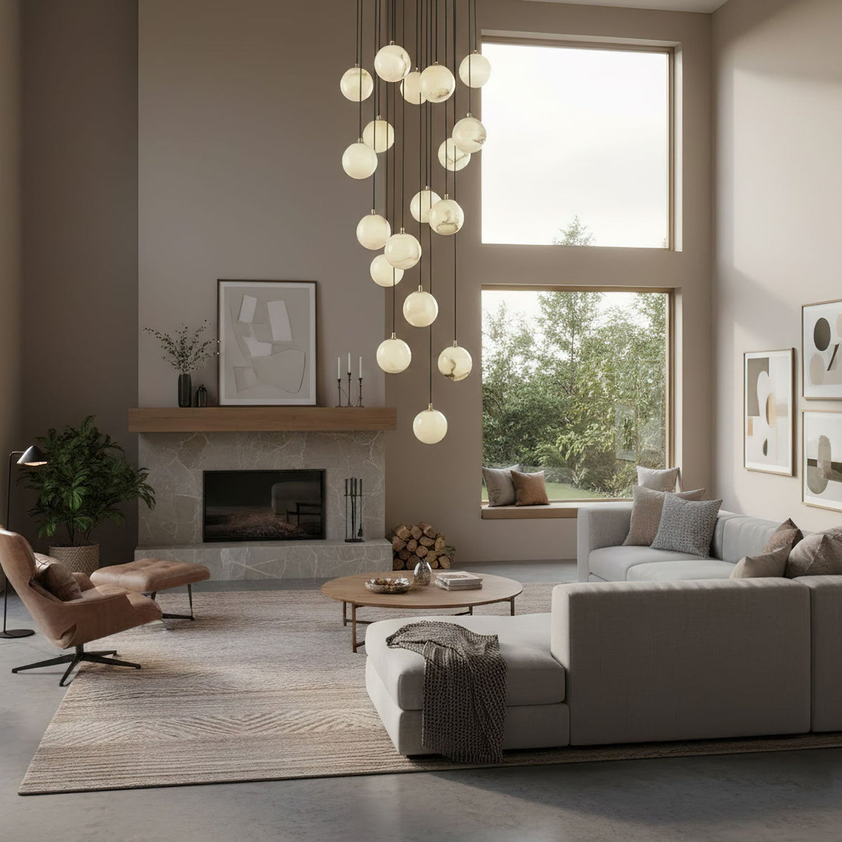 Tall Clérachic alabaster sphere cluster beside a large window in a grey-toned living room, with a leather lounge chair and a stone fireplace.