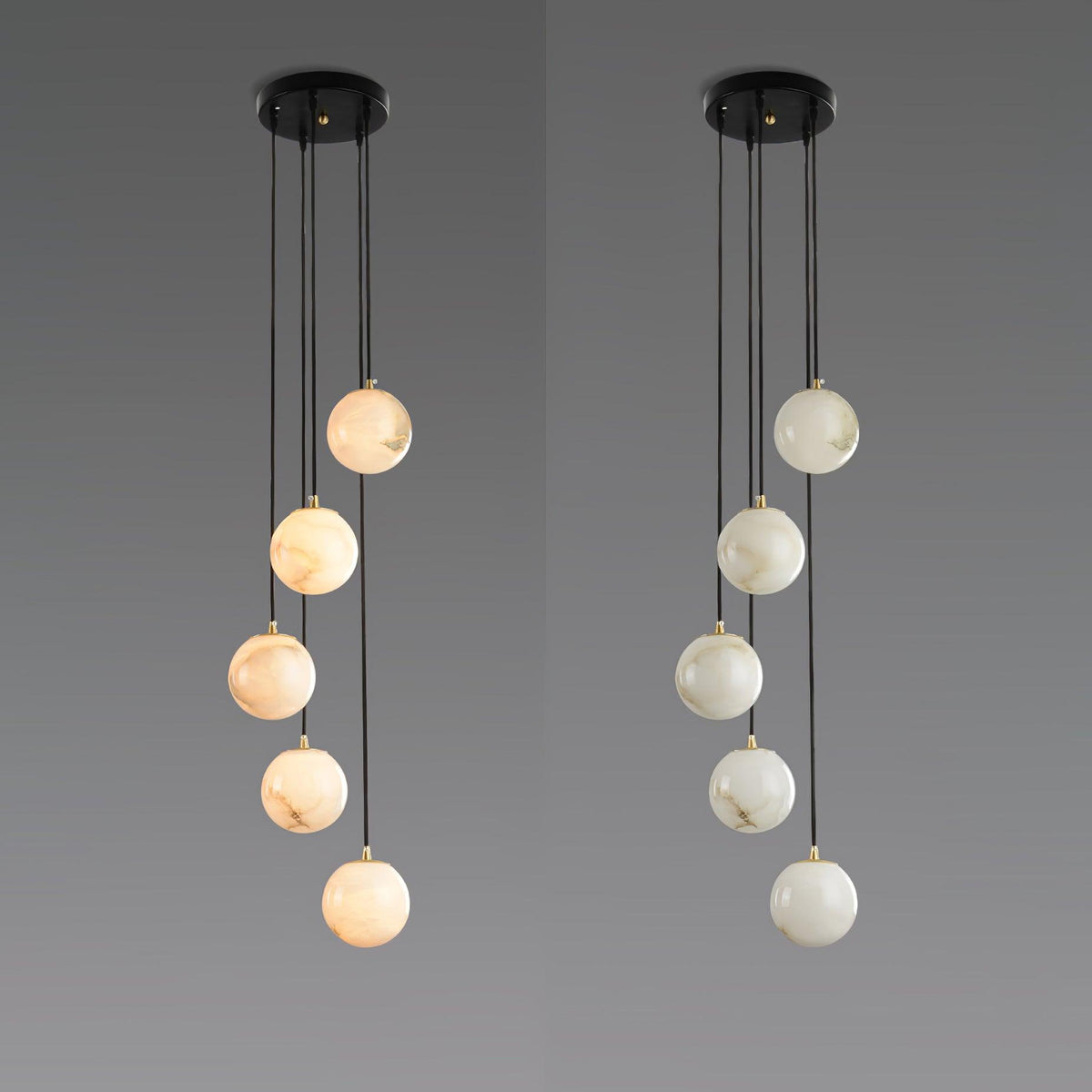 Two five-sphere Clérachic pendants side by side on grey, one with warm-toned alabaster spheres and one with paler spheres.