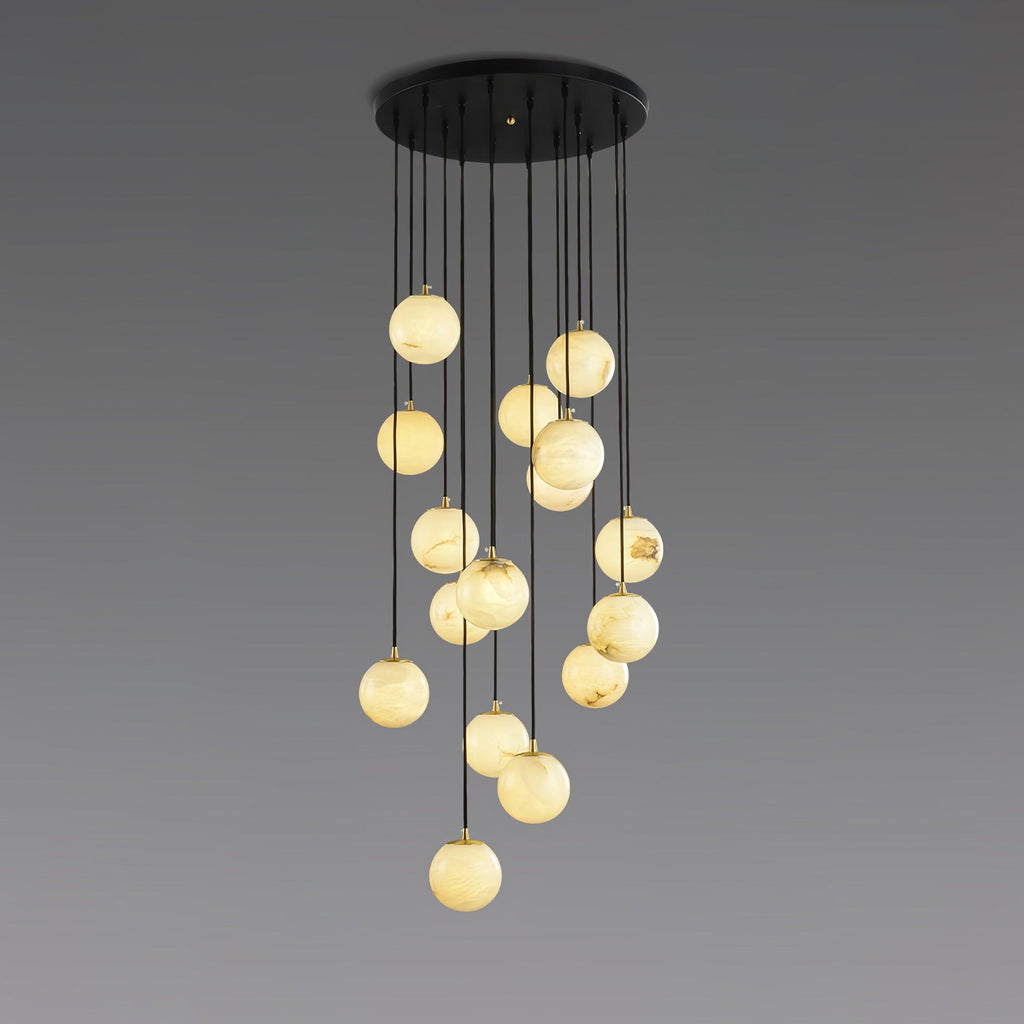 Clérachic cluster of lit alabaster spheres on black cords from a round canopy, shown against a grey gradient backdrop.