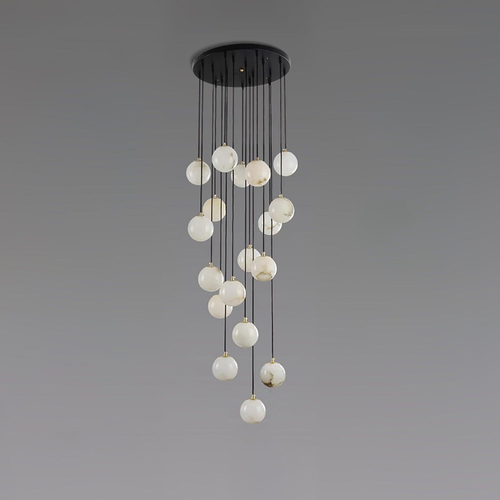 Clérachic cluster of pale, white-toned alabaster spheres hanging from a round black canopy, on a grey backdrop.