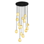 Warm-toned Clérachic alabaster sphere cluster on black cords below a round black canopy, on a white backdrop.