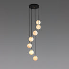 Six warm alabaster spheres from Clérachic hang from a round black canopy on a grey backdrop.