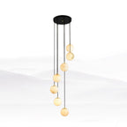 Seven Clérachic alabaster spheres at stepped heights from a round black canopy, in front of a faint misty landscape.