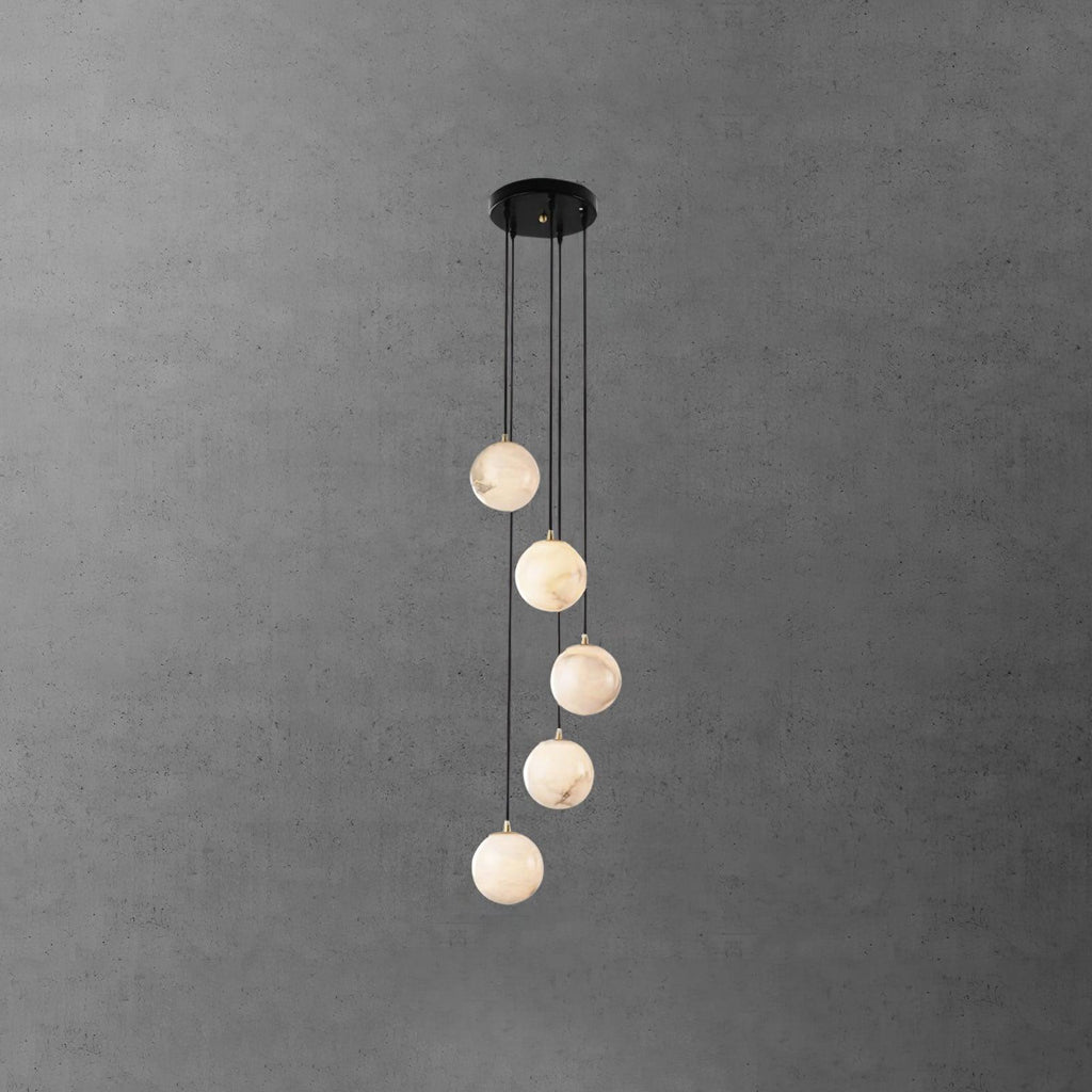Five Clérachic alabaster spheres at stepped heights from a round black canopy, in front of a dark grey textured wall.