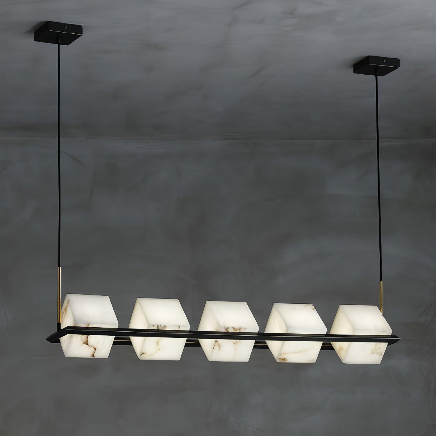 The linear Clérachic box chandelier, five alabaster cubes threaded along one long black bar.