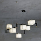 The Clérachic box chandelier with eight alabaster cubes spread across a wide black frame.