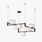 The Clérachic box chandelier on white, black arms and brass joints holding the alabaster cubes.
