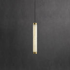 The Clérachic pendant in its shorter round size, one honey-lit alabaster tube capped top and bottom in brass.
