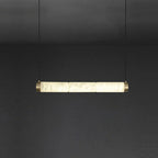 Clérachic alabaster bar pendant turned horizontal, glowing stone segments held between two brushed brass end caps.