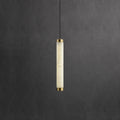 Clérachic pendant lit from within, the stone's cloudy veining reading warm cream against a charcoal wall.