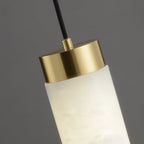 Clérachic pendant close up at the brushed brass top cap, where the black cable meets the alabaster tube.