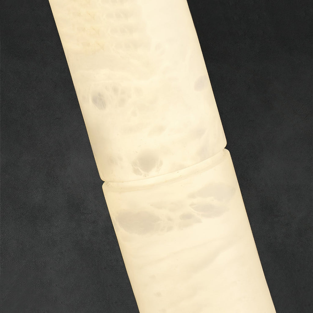 Clérachic alabaster in detail, cloudy white veining and the fine joint seam running through the lit stone body.