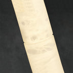 Clérachic alabaster in detail, cloudy white veining and the fine joint seam running through the lit stone body.