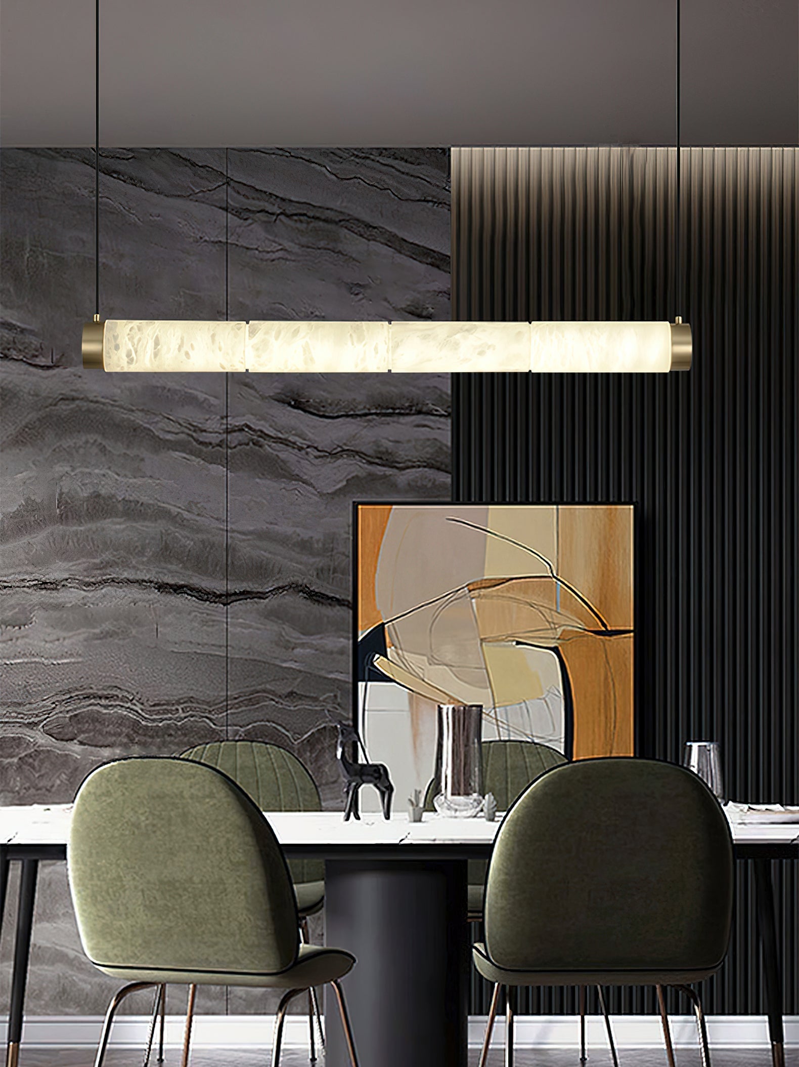 Clérachic strip pendant spanning a dining table, a long bar of lit alabaster against a veined grey stone wall.