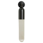 Black-finish Clérachic Alabaster Tube Wall Sconce seen face-on, the domed cap and twin ball joints sitting above the stone.