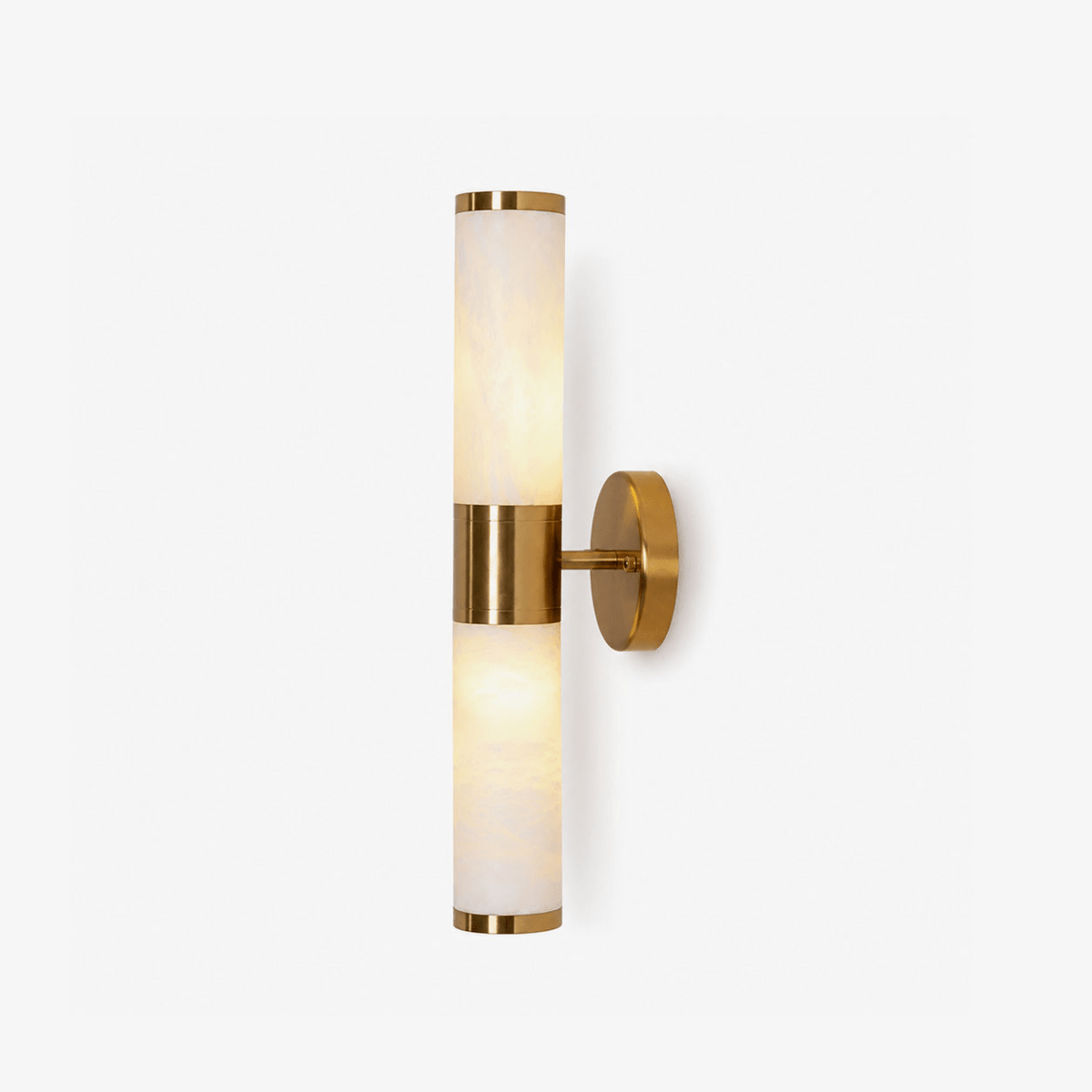 Two stacked alabaster-look tubes joined by a gold band and a round gold wall plate, this Clérachic wall light shown on a plain white backdrop.