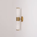 Side view of the unlit Clérachic wall light, with soft grey veining in the white tubes and thin gold rims at each end.