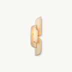 A slim Clérachic wall lamp of layered beige panels with a glowing alabaster centre, shown on a plain white backdrop.