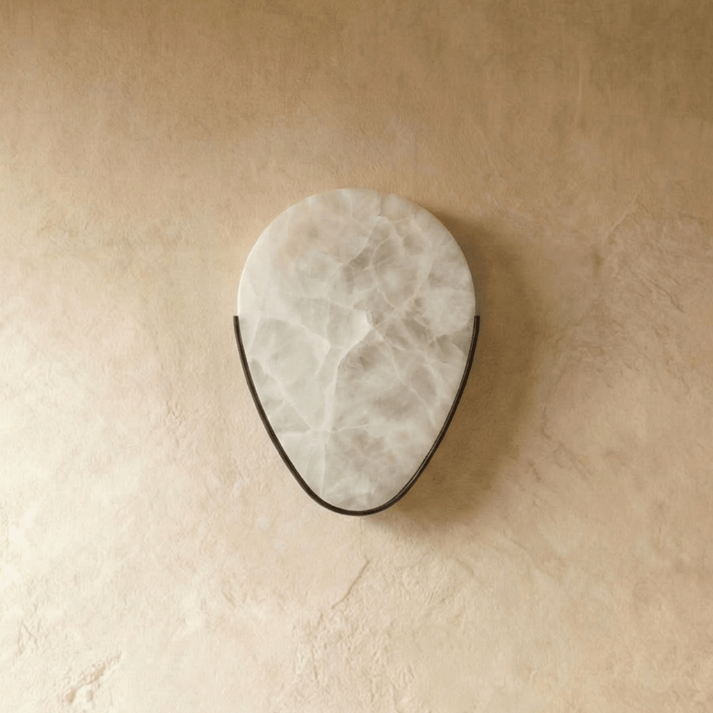 Clérachic alabaster wall sconce switched off, showing the pale veined stone cradled in a thin dark metal arc on plaster.