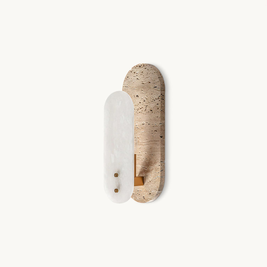 Angled view of this Clérachic wall light on a plain white backdrop, a white alabaster oval set against a taller beige travertine plate.