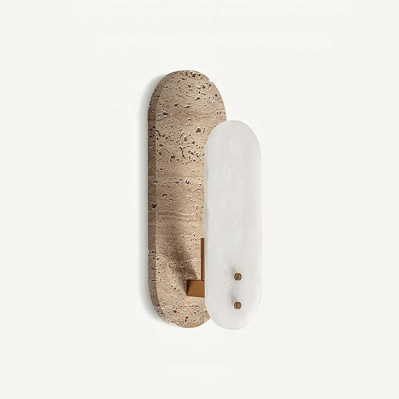 A Clérachic wall light seen from a slight angle on a white backdrop, with brass-coloured screws on the white alabaster oval.