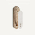 A Clérachic wall light seen from a slight angle on a white backdrop, with brass-coloured screws on the white alabaster oval.