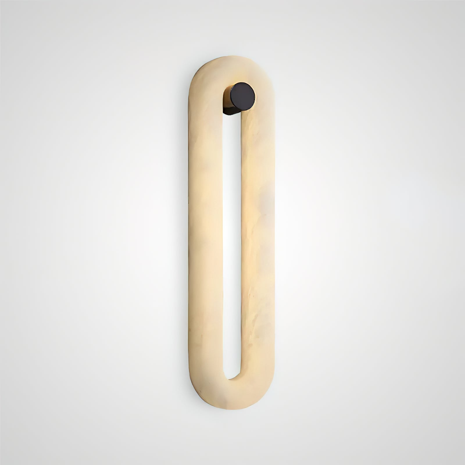 Clérachic Alabaster Wall Sconce lit and shown alone at an angle, warm light rising through the honey-veined stone.