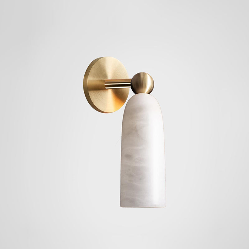 Clérachic alabaster wall light in profile, its brass disc, arm and ball joint set off against a pale grey backdrop.